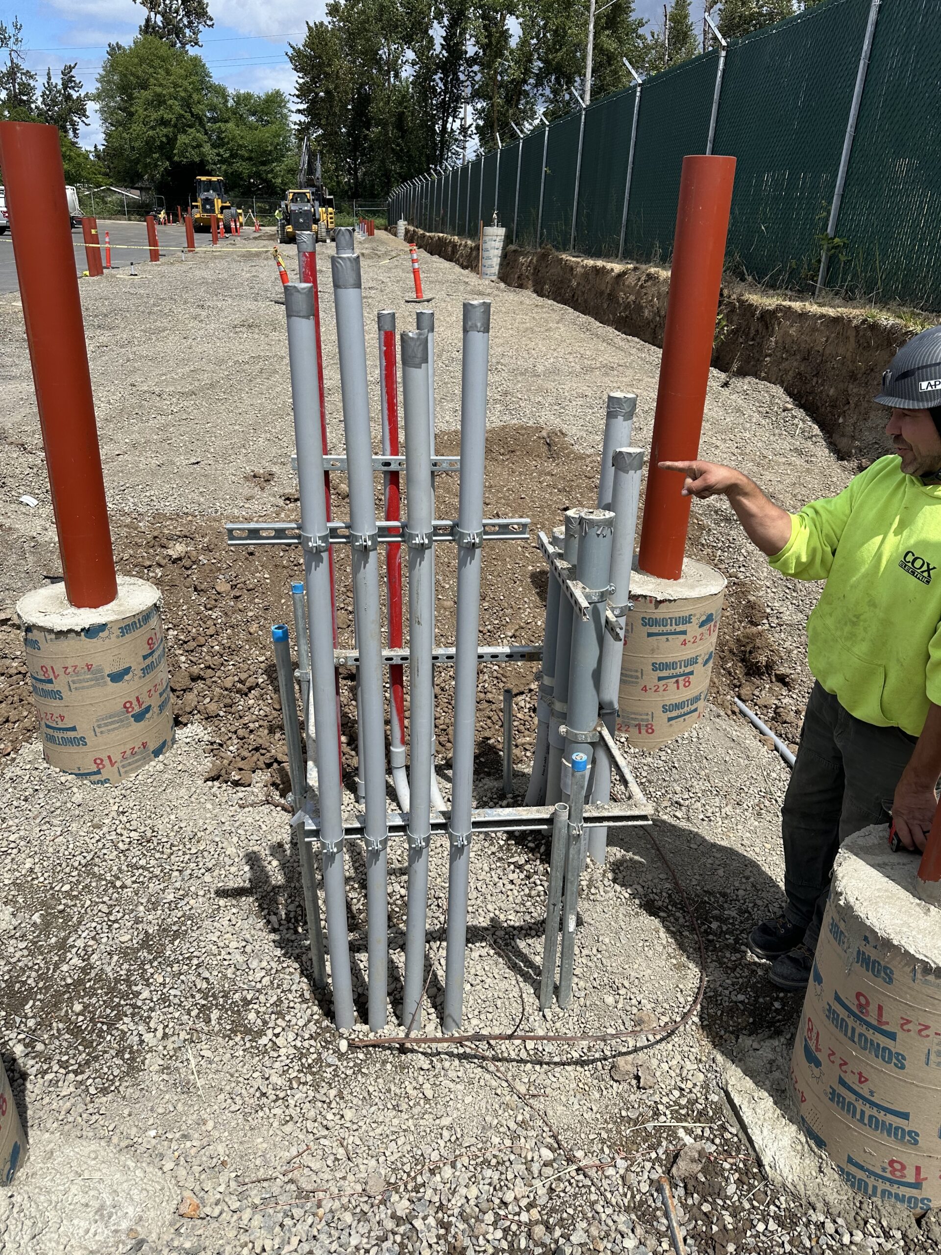 Electrical infrastructure site with underground conduit and EV charger installation work